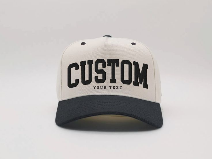 a white and black baseball cap with the word custom on it's front side