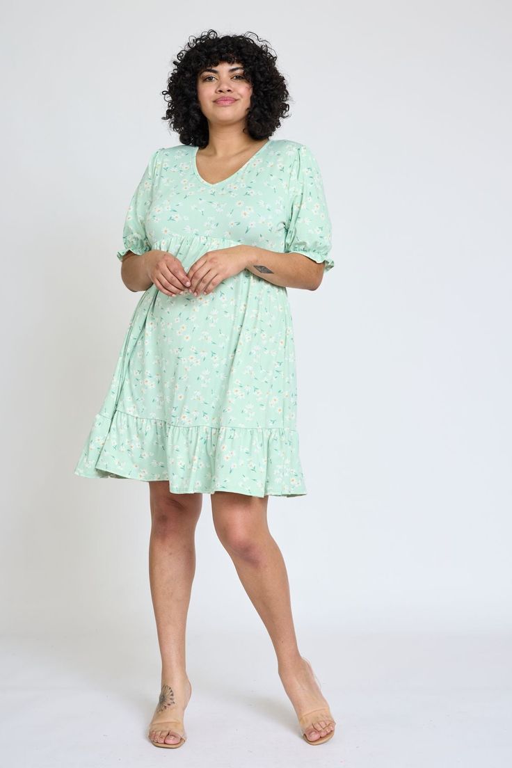 You will absolutely love this floral mini dress's delicate, feminine look that is perfect to add to your closet for Spring! This lovely dress is adorn with a v-neckline and a adorable ruffle trim at the hem and sleeves. 95% Polyester 5% Spandex Made in the USA V-neck, short puff sleeve, ruffle trimmed sleeves and hem, empire waistline with elastic, above the knee length SIZE: (Fits true to size) S(2-4), M(6-8), L(10-12), XL(14-16), 1X(18), 2X(20), 3X(22) S: Bust 34.5" Waist 30" Length 36"M: Bust Spring Daisy, Delicate Feminine, Short Puff Sleeve, Empire Waistline, Blue Springs, Floral Ruffle, Feminine Look, Lovely Dresses, Floral Mini Dress