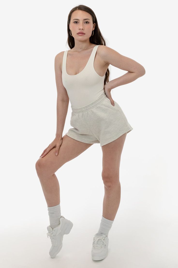 These short shorts are made of our bouncy 12 oz. cotton fleece, making them comfy, easy and versatile. Take your regular size or size up for a looser fit. This style features an elastic waistband, and a single back pocket. Try pairing with our matching sweatshirts or a neutral crop top or bodysuit. This fleece is made of a soft, combed cotton to keep you cozy and warm. Made in Los Angeles, Calif. Our experienced sewers earn up to $25 an hour and no less than $16; additionally workers have health Neutral Crop Tops, Bus Pass, Matching Sweatshirts, Fleece Shorts, Short Shorts, Cotton Fleece, Combed Cotton, Loose Fitting, Crop Top