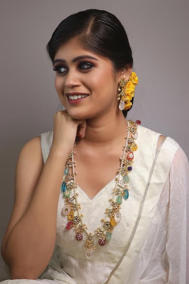 Gold toned, brass finish pre-layered necklace with multi colored semi-precious stones, kundans and shell pearl strings.
Type: Stone, Kundan, Pearls
Composition: Brass
Color: Multi Color, Gold
Stone drops
Size (cm): L x B: Necklace: 48 x 2
Weight (gm): 225
Closure: Lobster clasp
Note: The earrings shown in the image is not for sale - Aza Fashions Beads Necklace Indian, Long Beads Necklace, Long Necklace Gold, Sabyasachi Bridal, Bridal Jewellery Earrings, Kundan Set, Gold Long Necklace, Long Beaded Necklace, Pearl Choker Necklace