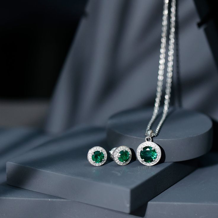 Product Details For those in search of a sophisticated and eye-catching office wear accessory, look no further than this Created Emerald Jewelry Set. Featuring a stunning Round Cut Created Emerald and Zircon in a Halo Style, this gold set is sure to make a statement. Product Information SKU SHP-PENDANT122040744 Length 18.5 mm Width 12 mm Weight 4.88 gm (Approximate) LAB CREATED EMERALD INFORMATION No.of Stones 3 Pieces Total Weight 3.78 Carat (Approximate) Dimension(approx) Round-6X6 mm-2 PcsRound-8X8 mm-1 Pcs Color Green Cut Brilliant Shape Round Setting Type Prong-Setting Quality Grade AAAA ZIRCON INFORMATION No.of Stones 56 Pieces Total Weight 0.99 Carat (Approximate) Dimension(approx) Round-1.20X1.20 mm-36 PcsRound-1.40X1.40 mm-20 Pcs Color White Cut Brilliant Shape Round Setting Type Elegant Green Jewelry With Halo Design, Elegant Green Jewelry With Halo, Elegant Green Halo Jewelry, Green Emerald Jewelry With Halo Detail, Green Emerald Halo Jewelry, Fine Jewelry Green Halo Earrings, Halo Green Fine Jewelry Earrings, Green Halo Earrings Fine Jewelry, Elegant Green Halo Earrings