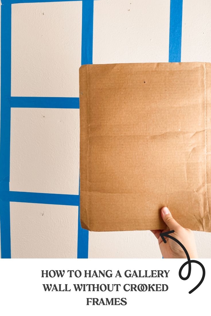 Hand holding a piece of cardboard against a wall marked with a blue grid layout, with text overlaying the image: "How to hang a gallery wall without crooked frames." How To Hang Gallery Wall Straight, Outdoors Themed Nursery, Gallery Wall Tips, Blue Canister Set, Recovering Chairs, Gallery Wall Hanging, Family Photo Wall, Wall Inspiration, Gallery Wall Inspiration