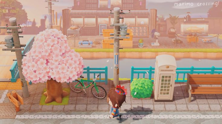 an animal crossing the street in front of a city with tall buildings and telephone poles