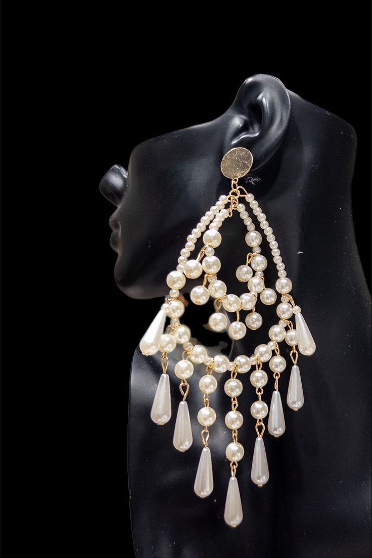 The Pearl Chandelier Statement Earrings are a stunning and elegant accessory that are sure to elevate any outfit. These earrings feature a cascading design of delicate pearls, arranged in a chandelier-style drop that creates a glamorous, eye-catching effect. Crafted from high-quality materials, these earrings are both durable and lightweight, making them comfortable to wear for extended periods of time. The pearls used in the design are carefully selected for their luster and quality, adding a t Pearl Chandelier Earrings, Pearl Chandelier, Chandelier Style, The Pearl, Elegant Accessories, Pearl Studs, Chandelier Earrings, Ring Bracelet, Earring Necklace