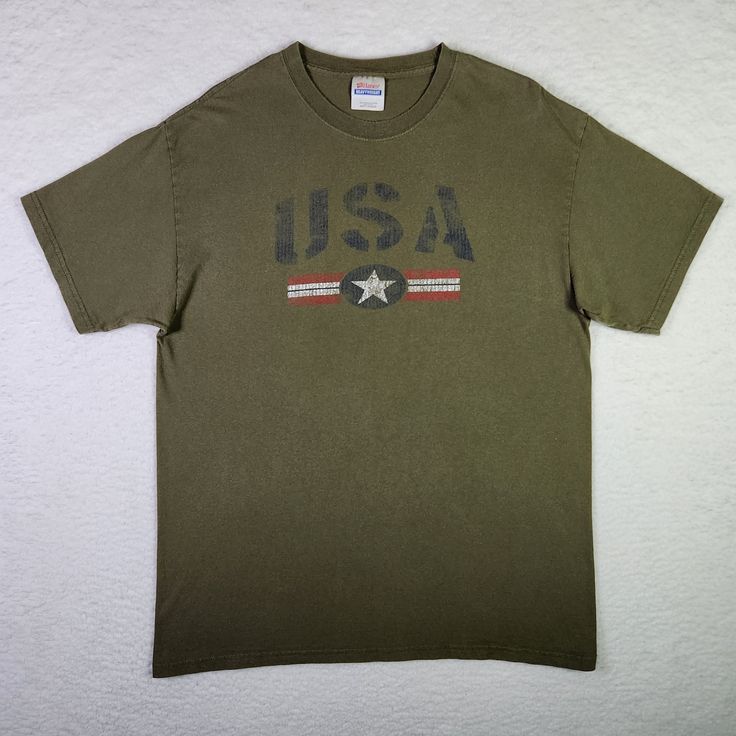 VINTAGE USA Shirt Large Olive Green America Patriotic Crew Neck T-shirt Mens  Excellent Vintage Condition  Size: Large  Color: Olive Green  100% Cotton Machine Washable  See photographs for MEASUREMENTS *To ensure the best fit, please measure the chest and total length of your favorite-fitting shirt and compare measurements to those of this particular item Same Day - Next Business Day Shipping Show off your patriotism with this vintage USA shirt in olive green. Made by Hanes, this shirt features American Boy, Usa Shirt, Vintage Usa, Classic American, Flag Design, Mens Graphic Tee, Jersey Fabric, Neck T Shirt, Olive Green