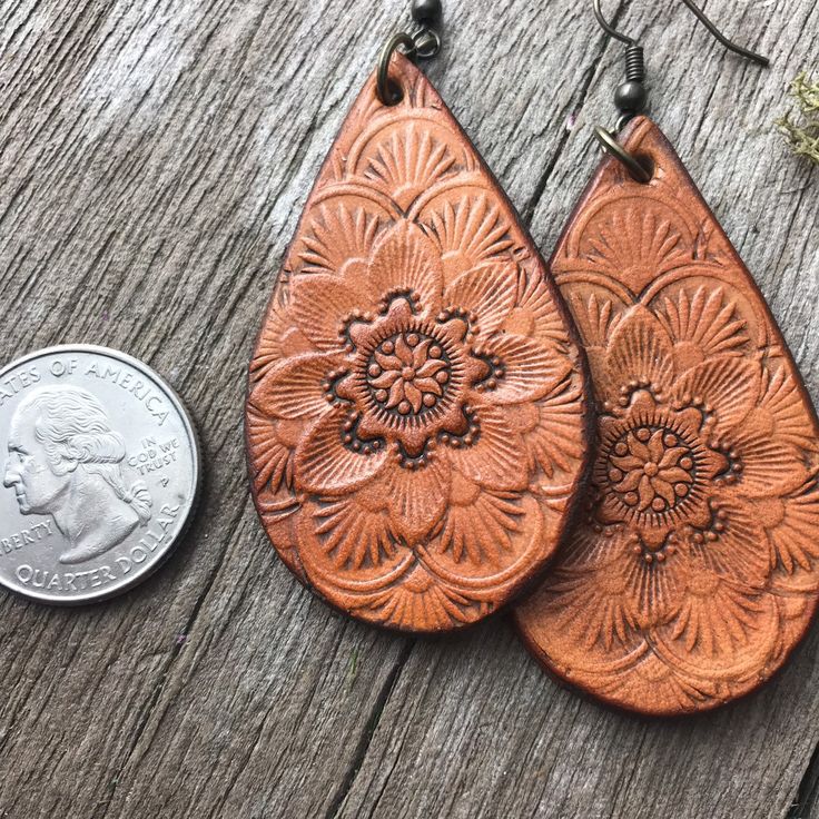 "Hand tooled leather earrings. Premium veg tanned leather. Handmade from start to finish. We love and take great care in what we do and it translates to every detail of your beautiful leather piece. These earrings are approximately 2.25\" in length and 1.25\" wide. Each of pair of these have their own unique characteristics because they are handmade. Hand tooled in a unique design and Hand dyed a rich caramel color. Warm and organic. Pair these with any favorite outfit! Antiqued brass findings. Tooled Leather Earrings, Leather Crafts, Veg Tan Leather, Unique Characteristics, Hand Tooled Leather, Memphis Tn, Caramel Color, Leather Pieces, Tooled Leather