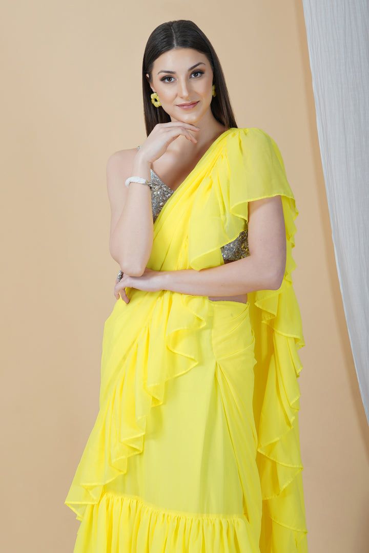 Groove at the cocktail party or a friend's wedding in this stunning frilly saree. Whimsical and lightweight, it is well paired with a contrasting strappy silver blouse that enhances the overall appeal to make it a perfect pick this season.Style Frill saree Silver embellished blouse Sunshine yellow hue Georgette fabric Specifications Model height - 5'9" Model wearing - S Frill Saree, Silver Blouse, Embellished Blouse, Sunshine Yellow, Georgette Fabric, It Is Well, Friend Wedding, Model Height, Cocktail Party