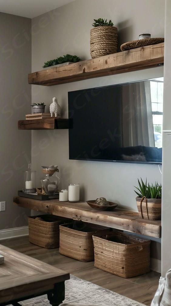 a flat screen tv sitting on top of a wooden shelf next to two baskets filled with plants