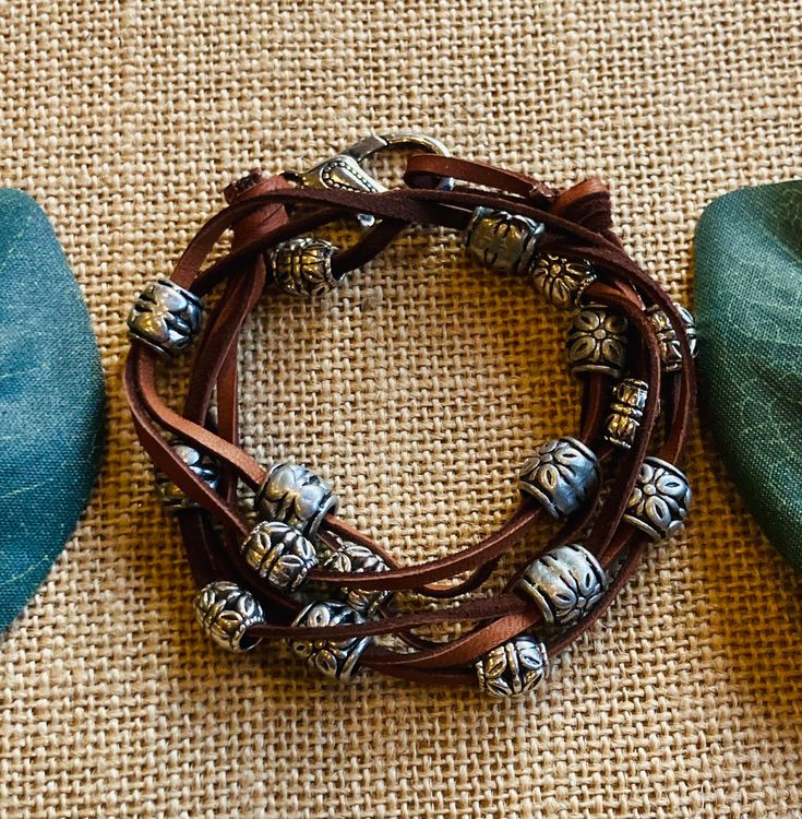 Leather bracelet with silver colored metal beads that wraps around wrist twice.  This bracelet is 18 inches in length and can double as a necklace.  This necklace is Southwestern style with boho charm! Bohemian Multi-strand Silver Beaded Bracelets, Bohemian Silver Wrap Bracelet, Nickel Free, Silver Bohemian Wrap Bracelet Nickel Free, Nickel Free Silver Bohemian Wrap Bracelet, Nickel-free Silver Bohemian Wrap Bracelet, Bohemian Nickel-free Silver Wrap Bracelet, Southwestern Brown Hand Wrapped Bracelets, Southwestern Hand-wrapped Wrap Bracelet For Gift, Southwestern Hand Wrapped Wrap Bracelet Gift