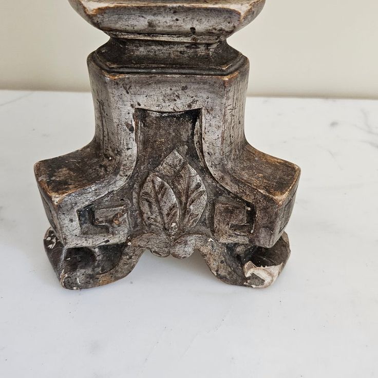 an old toilet sitting on top of a white counter