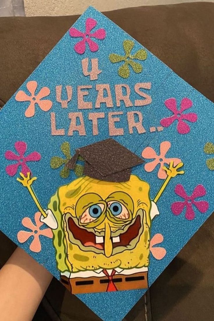 a blue graduation cap with an image of spongebob on it that says, i years later