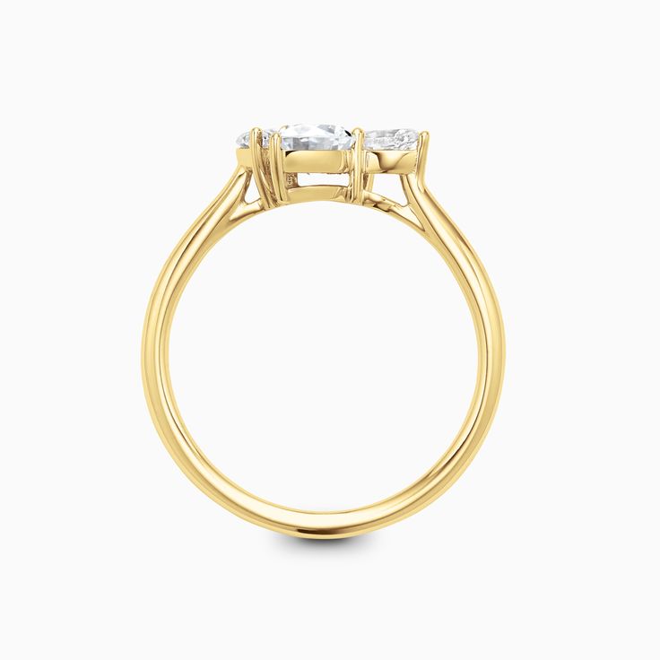 a yellow gold ring with three stones on the side