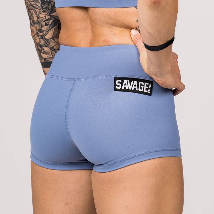 These Butter Soft Booty Shorts are all the rage! Periwinkle blue gym shorts that move with you—not against you. Our classic solid color booty shorts are a must-have for every woman that is serious about her fitness journey. Savage classic booty shorts are custom-made with a perfect blend of Butter Soft nylon and spandex. Our 4-way stretch performance fabrics are soft, comfortable, squat proof, and stay in place so you can achieve full range of motion in and out of the gym. With our light blue sp Cheerleading Athleisure Shorts, Blue Short Boxer Briefs For Training, Blue Squat Proof Athletic Shorts, Squat Proof Blue Athletic Shorts, Athleisure Moisture-wicking Shorts For Cheerleading, Blue Short Boxer Briefs For Workout, Blue Boxer Briefs With Built-in Shorts For Sports, Blue Squat-proof Running Bottoms, Moisture-wicking Shorts For Cheerleading