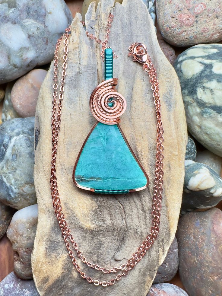 "Gem silica with copper and pacific blue wire wrap Comes with 18\" sterling silver plated chain shown in photos. Pendant measures 1-13/16\" x 15/16\"" Turquoise Necklace With Copper Wire, Wire Wrapped Turquoise Pendant Necklace, Turquoise Copper Wire Necklace Gift, Blue Copper Wire Pendant Necklace, Turquoise Copper Wire Necklace As Gift, Turquoise Copper Wire Necklace For Gift, Blue Copper Wire Wrapped Necklaces, Blue Copper Wire Wrapped Necklace, Blue Pendant Necklace With Copper Wire