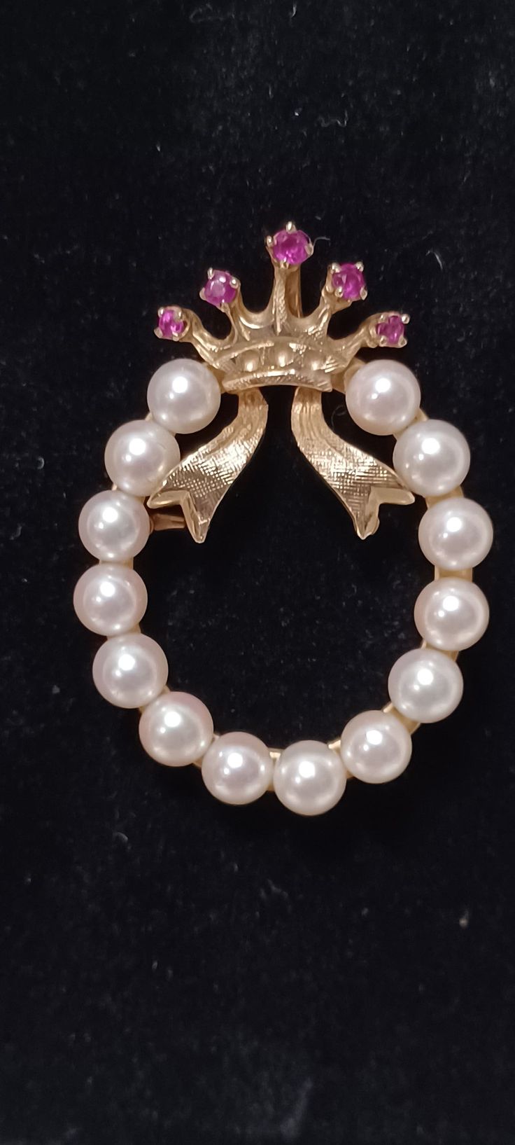 MCM Vintage Estate 14k Yellow Gold White Pearl Wreath with a Ruby Crown and Ribbon Brooch/Pendant This piece is delicate, classic, speaks volumes, is in wonderful condition and will make a great gift for that special someone.  (Remember you are a special someone also.) The brooch/pendant has a round safety catch closure, measures approximately 1 1/2 inches long, approximately an inch wide and weighs approximately 7 grams. The crown is inset with 5 round faceted rubies weighing .17 carats    The wreath consists of 14 4.5-5 mm white cultured pearls  The piece is stamped Lj, with a star above the j, and 14k Can also be turned into a pendant, be aware, the the pin closure will be visible. THE NECKLACE CHAIN IS NOT INCLUDED IN THE LISTING.  YOU WILL NEED TO PROVIDE YOUR OWN CHAIN TO TURN IT INT White Oval Brooch For Formal Occasions, Timeless Wedding Brooch Jewelry, Collectible Fine Jewelry Brooch, Fine Jewelry Brooch For Collectors, Heirloom Style Formal Necklace With Brooch, Elegant Anniversary Brooch Jewelry, Timeless Jewelry Brooch As Gift, Timeless Jewelry Brooch For Gift, Timeless Gift Jewelry Brooch