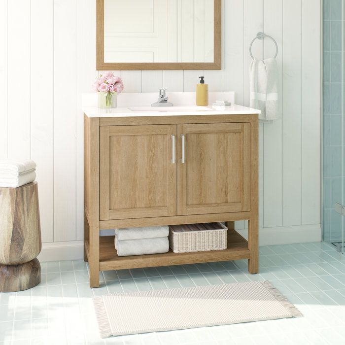 a bathroom with a sink, mirror and shower in it's center area is shown