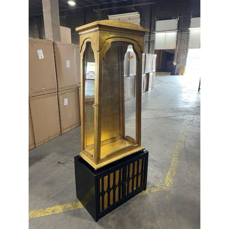 an old fashioned grandfather clock in a warehouse