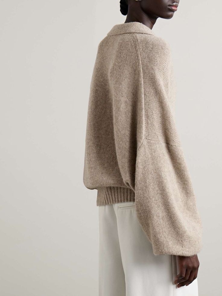 KHAITE Rene oversized cashmere polo sweater | NET-A-PORTER Oversized Cozy Workwear Tops, Cozy Oversized Fine Knit Tops, Oversized Knit Turtleneck Sweatshirt, Oversized Fine Knit Sweater For Work, Oversized Beige Sweater With Ribbed Collar, Oversized Wool V-neck Sweater For Fall, Classic Oversized Turtleneck Top, Classic Oversized Turtleneck Sweater, Long Sleeve Cashmere Sweater For Loungewear