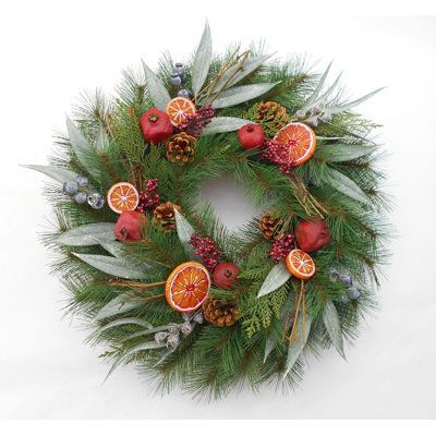 a christmas wreath with oranges and pine cones