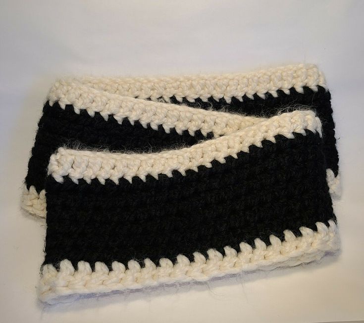 two black and white crocheted items on a table