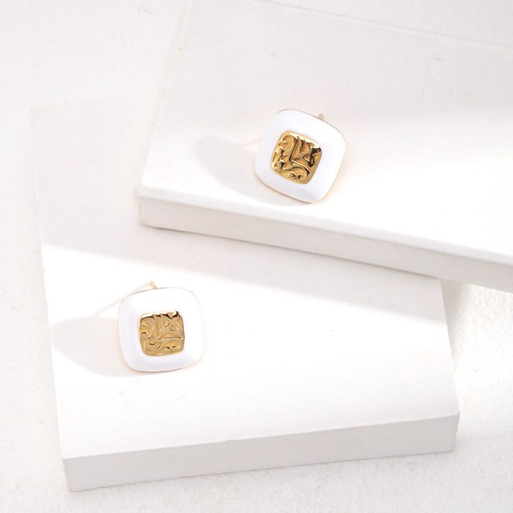 Introducing our Sterling Silver Square Drop Glaze Stud Earrings, where modern design meets classic elegance. Contemporary Square Design: These earrings feature sleek and minimalist square-shaped studs, adding a touch of modern sophistication to any outfit. The clean lines and geometric shape make them perfect for both casual and formal occasions.Glaze Finish: Each stud is adorned with a glossy glaze finish, adding a subtle shine and depth to the design. The glaze creates a smooth and polished surface, enhancing the visual appeal of the earrings and catching the light beautifully.Sterling Silver Construction: Crafted from genuine sterling silver, these earrings offer durability, shine, and hypoallergenic properties for sensitive ears. Stud Earrings Style: The stud earrings style provides a Elegant Rectangular Enamel Jewelry, Luxury White Earrings For Everyday, Modern White Rectangular Jewelry, Elegant Square Tarnish Resistant Earrings, Elegant Square Tarnish-resistant Earrings, Modern White Rectangular Earrings, Modern White Enamel Jewelry, Modern White Earrings With Plating, Modern White Plated Earrings