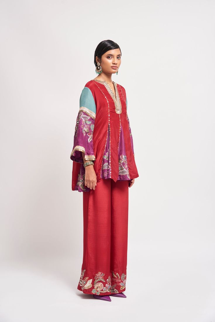 Auburn red applique embellished habutai silk short godet kurta, wide leg pants & teal dupatta. From Aisha Rao's Kinfolk collection. DELIVERY TIMEPlease allow 6-8 weeks for your outfit to arrive. FABRIC DETAILSSilk Professional cleaning only. Red Cotton Silk Sharara With Cutdana, Red Cotton Silk Sharara With Cutdana Details, Red Semi-stitched Cotton Silk Sharara, Red Cotton Silk Sharara With Traditional Drape, Red Slub Silk Sets For Festivals, Red Traditional Cotton Silk Sharara, Traditional Red Cotton Silk Sharara, Red Cotton Silk Kurta For Eid, Bollywood Style Red Cotton Silk Sharara