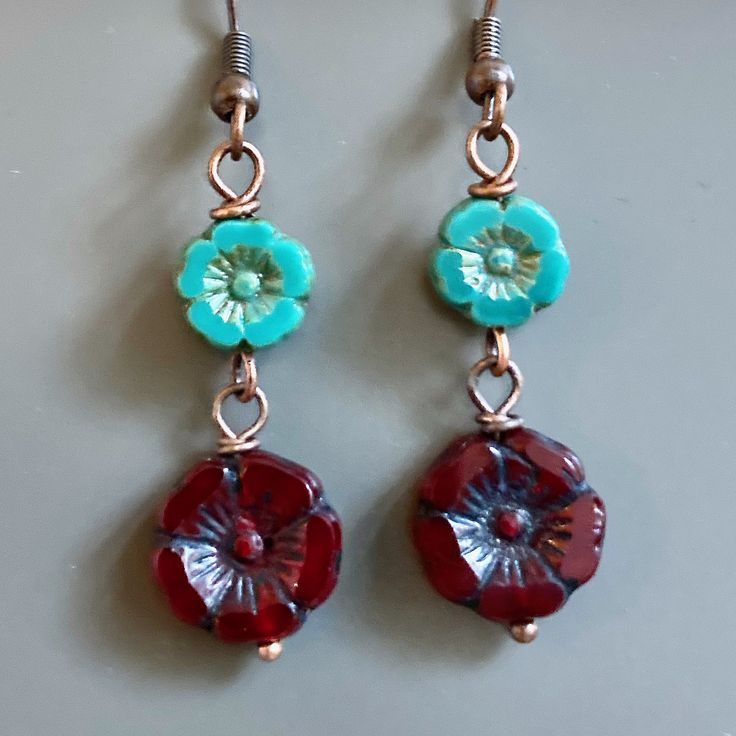 "Red and Turquoise Earrings - Dark Red Czech Glass Flower Beads dangle from Turquoise Czech Glass Flower Beads. Antiqued Copper plated Earwires Earrings measure just over 1.75\" from top of earwires to bottom of beads." Adjustable Red Flower Beaded Earrings, Turquoise Flower Charm Earrings For Gift, Turquoise Flower Earrings As A Gift, Gift Turquoise Flower Charm Earrings, Gift Turquoise Flower Earrings, Red Bohemian Flower Earrings, Bohemian Red Flower Earrings, Red Bohemian Dangle Flower Earrings, Handmade Red Flower Earrings With Round Beads