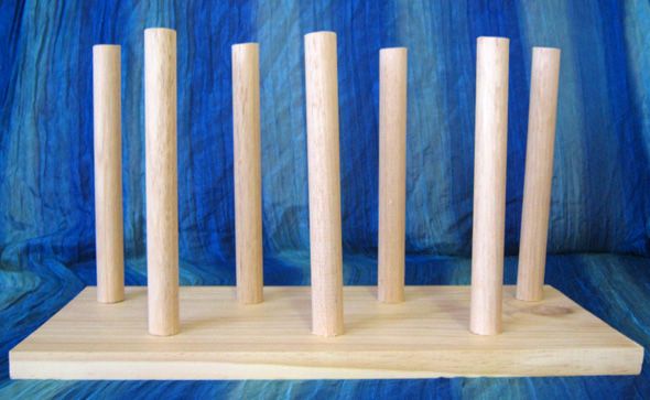 four wooden dowks on a stand with blue background