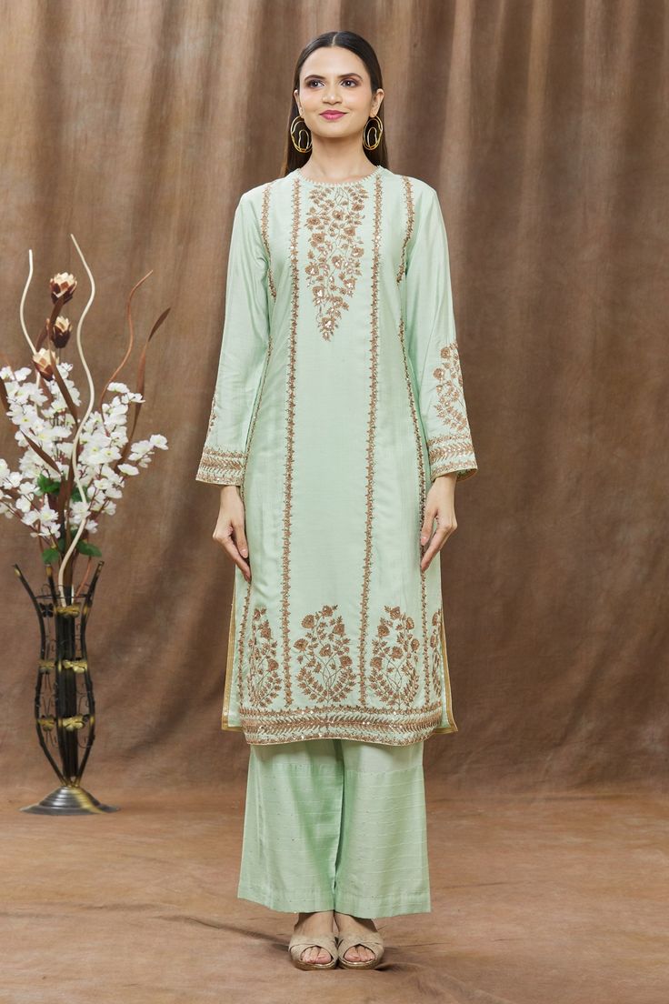 Mint green kurta with thread and sequin embroidery. Comes with straight pants and dupatta.
Component: 3
Pattern: Embroidery
Type Of Work: Thread and Sequin
Neckline: Round
Sleeve Type: Full
Fabric: Chanderi
Color: Green
Other Details: 
Dupatta with scalloped border
Side slits
Cutout detail at the neckline
Keyhole back
Closure: Loop back button
Occasion: Puja - Aza Fashions Pista Green Straight Kurta Sets With Mirror Work, Pista Green Sets With Mirror Work And Straight Kurta, Pista Green Palazzo Set With Mirror Work, Traditional Green Palazzo Set For Reception, Pista Green Sets With Mirror Work For Eid, Elegant Semi-stitched Green Palazzo Set, Elegant Green Semi-stitched Palazzo Set, Unstitched Sets For Reception With Straight Kurta, Green Chinon Set For Navratri