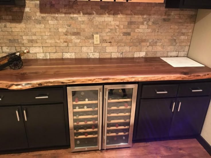 a kitchen counter with two wine coolers in it