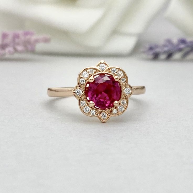 ITEM SPECIFICATIONS: Material: Solid 925 Sterling Silver With Rose Gold Plating (Yellow And White Rhodium Plated Also Available) -The Main Stone Is A Round Cut 6mm Lab Created Pink Ruby Stone -Side Stones Are Round Cut 1.3mm and 1.1mm Simulated Diamonds -Ring Is Cast In Solid 925 Sterling Silver With Rose Gold Plating (Yellow And White Rhodium Plated Also Available) -Total Face Height Of the Ring Measures 11mm -Band Width Measures Approximately 2mm -Please Message Us If You Need A Size That is N Yellow Gold Halo Ruby Ring For Wedding, White Gold Ruby Ring With Halo For Wedding, Anniversary White Gold Ruby Ring With Halo, Exquisite Yellow Gold Ruby Ring For Wedding, Classic Gemstone Flower Ring For Wedding, Exquisite Yellow Gold Ruby Wedding Ring, Classic Wedding Flower Ring With Gemstone, Wedding Sterling Silver Cluster Ring In Yellow Gold, Yellow Gold Halo Setting Wedding Jewelry