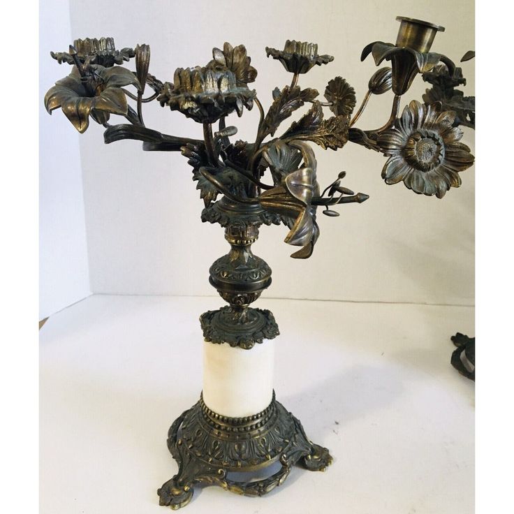 an ornate metal candle holder with flowers on it