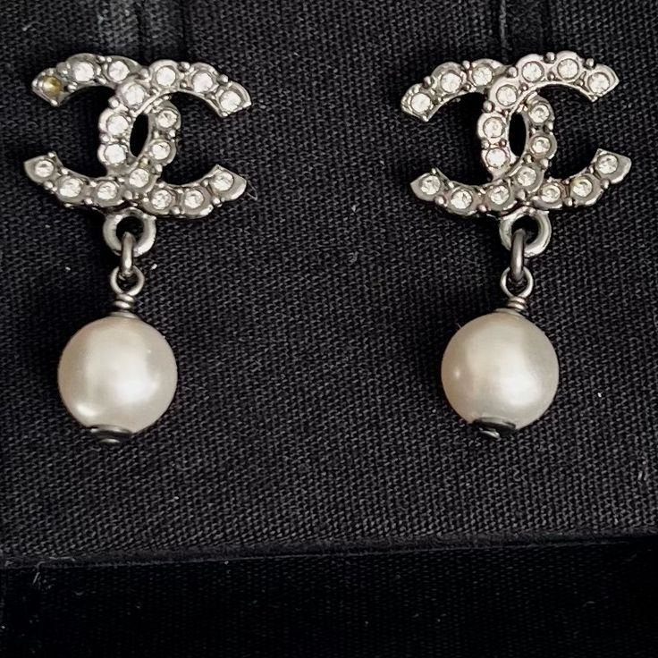 These Are Absolutely Stunning. Small Classic Cc Silver Crystal With A Faux Pearl Dangle. Can Be Worn For Daily Wear. These Are Brand New With A Small Blemish On One Of The Pearls From Storage-See Photo. There Is Also A Missing Crystal-See Photo Brand New- Have Been Stored In My Jewelry Chest Ships With Box, Ribbon, And Flower Approximate Size- This May Not Be Exact And Will Vary Depending On Placement Of Ruler- These Are Small Length: 0.5 In Height: 1 In Designer Dangle Earrings For Formal Events, Designer Dangle Earrings For Formal Occasions, Luxury Pearl Earrings For Evening, Luxury Aaa Quality Pearl Earrings For Formal Occasions, Luxury Aaa Quality Pearl Drop Earrings, Luxury Pearl Earrings, Chanel Stud Earrings, Chanel 2019, Cc Earrings