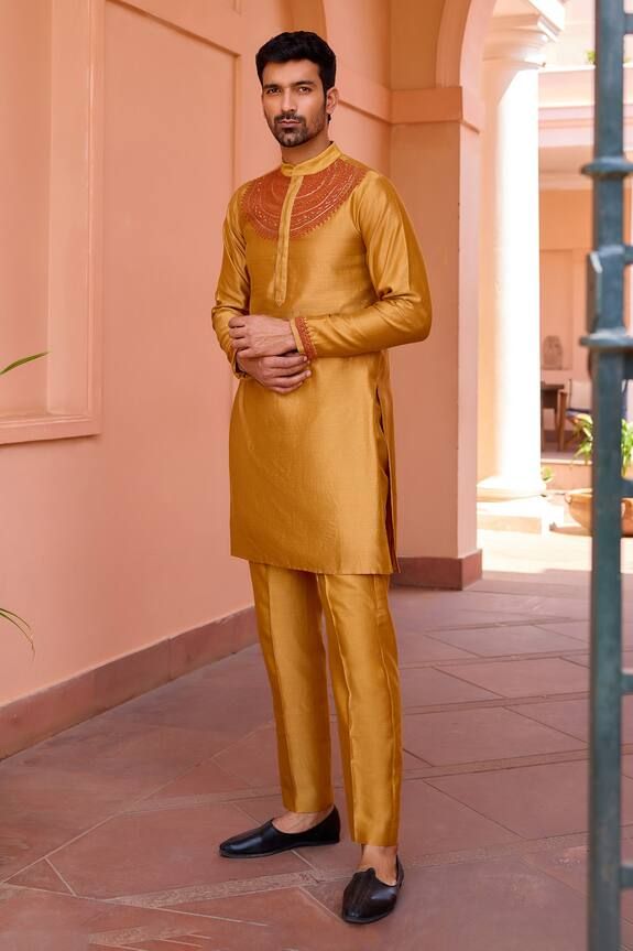 Gold kurta with marodi dori embroidery on the yoke. Paired with a pant. - Aza Fashions Traditional Gold Lawn Suit With Dabka, Festive Traditional Gold Lawn Suit, Traditional Raw Silk Lawn Suit For Festive Occasions, Traditional Drape Lawn Suit For Eid Ceremonies, Festive Lawn Suit With Dabka For Traditional Ceremonies, Traditional Gold Lawn Suit For Festivals, Traditional Lawn Suit With Dabka For Ceremonies, Gold Sherwani With Resham Embroidery For Navratri, Traditional Chanderi Dabka Wear