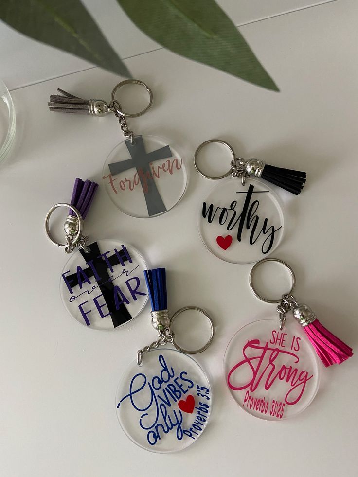 six key chains with different designs on them and one has a cross in the middle