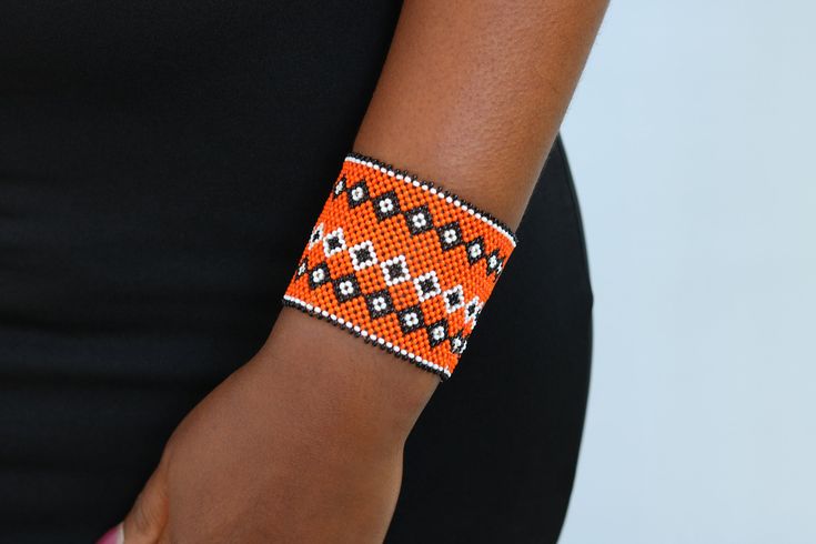 African beaded bracelets, Maasai Cuff Bracelets, Maasai Wrist bracelets, Beaded bangles, Beaded Cuff bracelets, Christmas gift, Moms gift The bracelet is made by the Maasai women in Kenya.  It is beautiful and can compliment any outfit. Available in medium and large size Medium size: fits a standard wrist size of 7.5 inches Large Size: fits a wrist size of 8.5 inches Shipping fee is for the first item only. Other items ship for FREE! Shipping via DHL Express that takes 3-5 days to be delivered. To view more items from our shop, kindly click here: nkoroicrafts.etsy.com Thank you for visiting! Maasai Bracelet Kenya, Handmade Orange Cuff Bracelet Bangle, Orange Beaded Bangle Bracelet As Gift, Handmade Orange Cuff Bangle, Handmade Orange Bangle Cuff Bracelet, Handmade Orange Cuff Bracelet Gift, Beaded Cuff Bracelet Gift, Handmade Beaded Cuff Bracelet As Gift, Traditional Beaded Wristband Gift