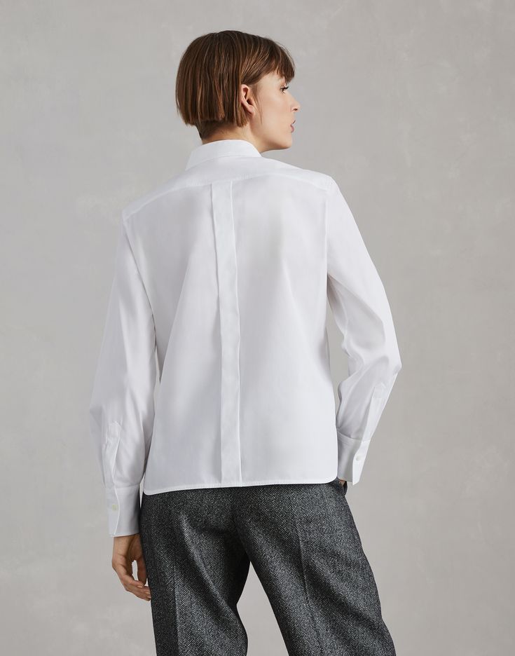 Stretch cotton poplin shirt with shiny ribbed detail Precious details update the essential style of this stretch cotton poplin shirt. The chest pocket is enriched with a delicate ribbed edge illuminated by a monili embroidery, adding a feminine touch to the garment’s classic lines. The slightly full effect of the sleeves highlights the shirt’s contemporary feel. Timeless Tailored Tops For Office, Timeless Slim Fit Tops For Office, Timeless Slim Fit Office Tops, Timeless White Workwear Tops, Timeless White Tops For Workwear, Timeless White Tops For Work, Modern Shirt With Welt Pockets For Work, Modern Workwear Shirt With Welt Pockets, Classic Tailored Tops For Office