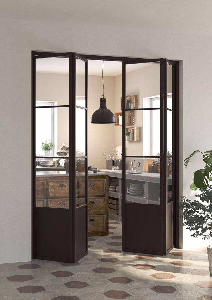 an open door leading into a kitchen with potted plants on the counter and floor