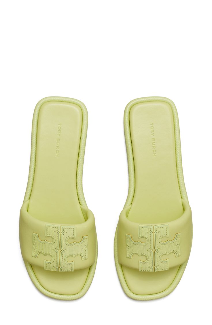 A sleek leather slide accented by Tory's signature double-T logo is ready to upgrade your warm-weather style. Leather upper and lining/rubber sole Imported Casual Green Leather Slides, Green Leather Slides With Cushioned Footbed, Green Leather Flat Slides, Classic Synthetic Slides With Branded Insole, Flat Slides With Leather Footbed, Designer Synthetic Slides Slip-on, Synthetic Flat Slides With Leather Footbed, Designer Synthetic Slip-on Slides, Classic Spring Slides With Rubber Sole