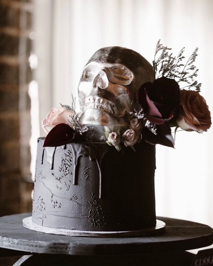 a cake decorated with flowers and a skeleton head