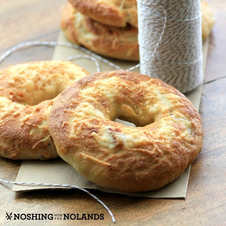 two bagels sitting on top of a piece of paper next to a canister