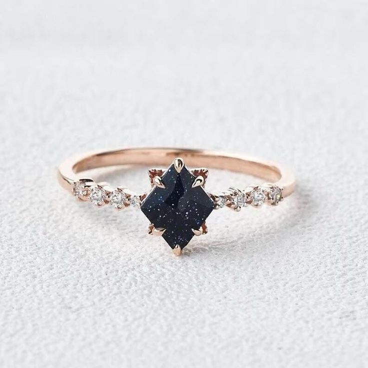 a black diamond ring with white diamonds on it