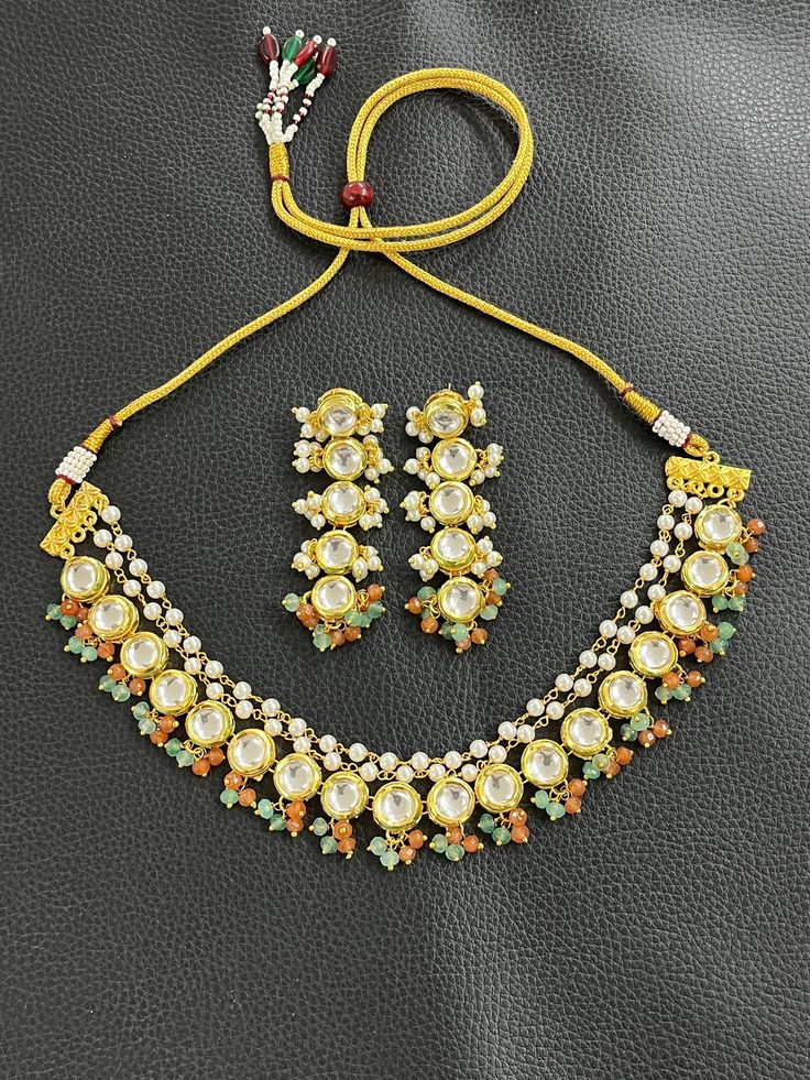 KUNDAN WEDDING BRIDAL NECKLACE CHOKER SET  Material :  HIGH quality GOLD plated brass, JADE, PEARL stones  Finish :  GOLD plated  Featuring :  LENGTH              ADJUSTABLE      Specility : 1. top RATED shop                    2. FREE delivery                    3. FAST delivery service                    4. lower PRICE from others                    5. HIGH quality products                    6. all jewelry items are made by HAND with                          LOVE and CARE                    7 Handmade Gold Kundan Necklace For Wedding, White Festive Necklace For Marriage, Festive White Necklace For Marriage, Festive White Wedding Necklace, Gold Beaded Kundan Necklace, Gold Kundan Necklace For Anniversary, Handmade, Kundan Necklaces For Marriage, Gold Hand Set Beaded Necklace For Gift, Hand Set Gold Beaded Necklaces Gift