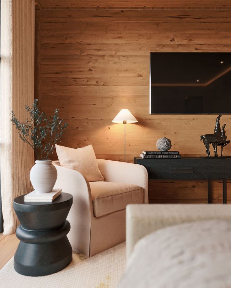 a living room filled with furniture and a flat screen tv mounted to the side of a wall