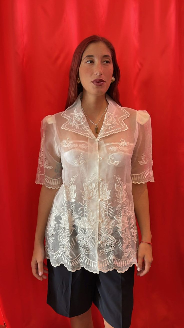 Amazing sheer short-sleeve shirt. Intricately with floral lace embroidery throughout, scallop edging at the Notch collar, sleeves and hemline. Made of sheer tulle with visible shoulder pads and finished with pearl buttons & loop fastening.  Size tag: Medium Classic Sheer Collared Tops, Classic Sheer Tops For Formal Occasions, Classic Sheer Top For Formal Occasions, Classic Fitted Blouse With Sheer Sleeves, Summer Lace Blouse With Lace Sleeves, Classic Blouse With Sheer Sleeves And Fitted Design, Elegant Sheer Collared Blouse, Sheer Feminine Lace Top, Elegant Summer Lace Top With Lace Sleeves