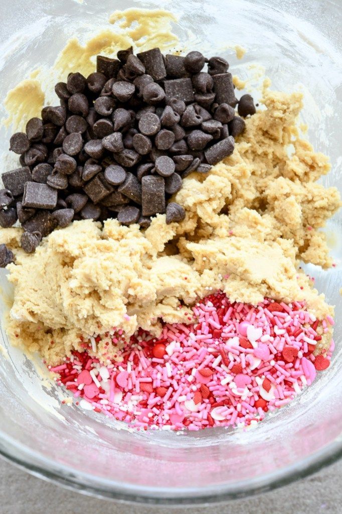 three ingredients in a glass bowl with chocolate chips, sprinkles and candy canes