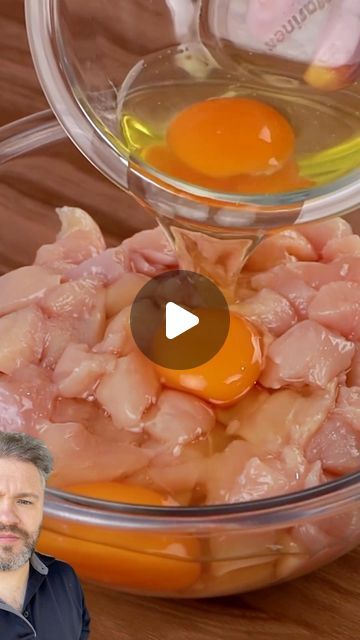 a man standing in front of a bowl filled with meat and an egg on top of it