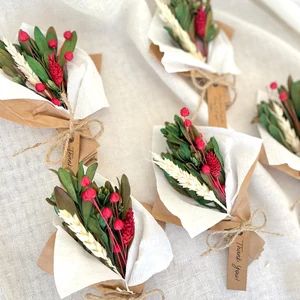 flowers are wrapped in brown paper and tied with twine on top of each other