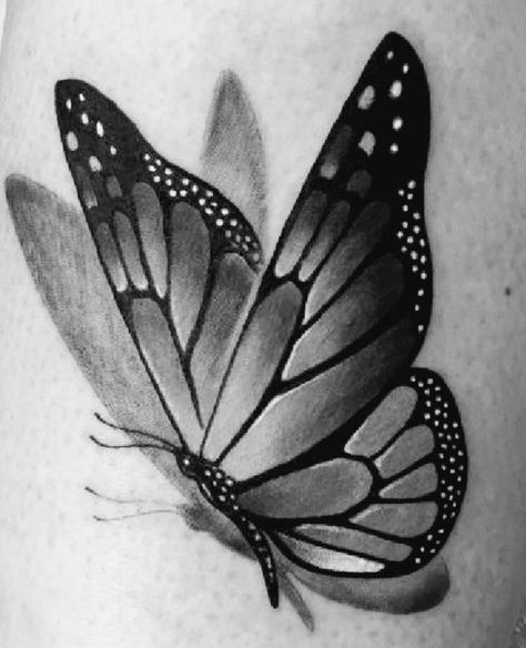 a black and white photo of a butterfly tattoo on the side of a woman's leg