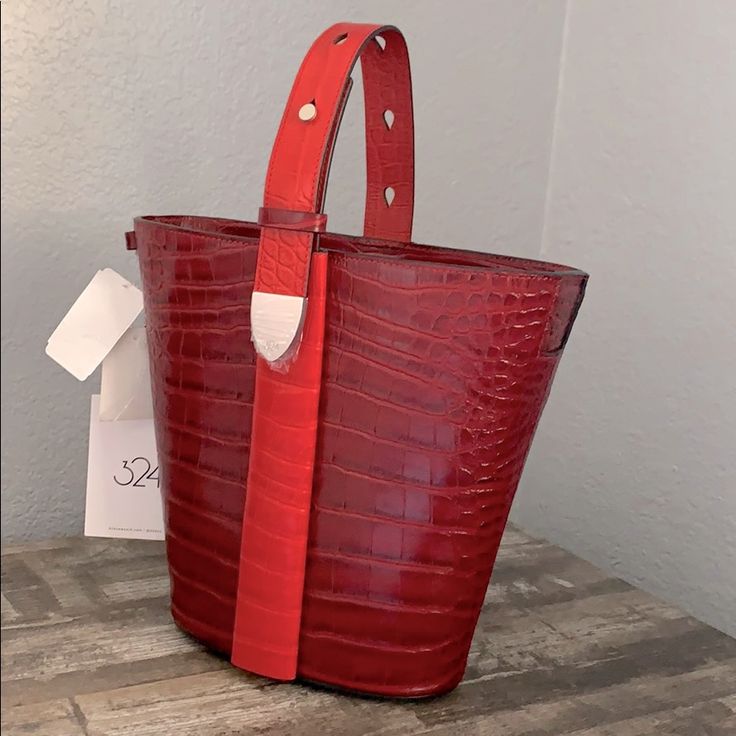 A Classic Anni-Croc Embossed Convertible Bucket Bag From 324 New York! Two Way Magnetic Closure And Adjustable Straps Allow You To Change The Look To Wear On Your Shoulder Or To Carry By The Top Handle. Enough Space For Essentials And Has Two Pockets Inside. 9"H 10.5w 4"D Let Me Know If You Have Any Questions. Red Luxury Bucket Bag With Detachable Handle, Luxury Red Bucket Bag With Detachable Handle, Luxury Red Bucket Bag With Detachable Strap, Red Top Handle Bucket Bag For Evening, Red Crossbody Bucket Bag For Formal Occasions, Red Evening Bucket Bag With Top Handle, Red Formal Crossbody Bucket Bag, Formal Red Crossbody Bucket Bag, Designer Red Rectangular Bucket Bag